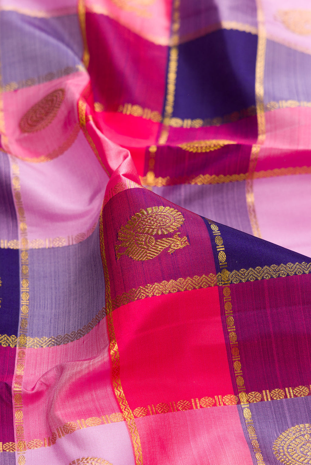 Close up of Pure Silk Multi Color Kanjivaram Saree with Checked design on the body and Zari Border.  displaying folds