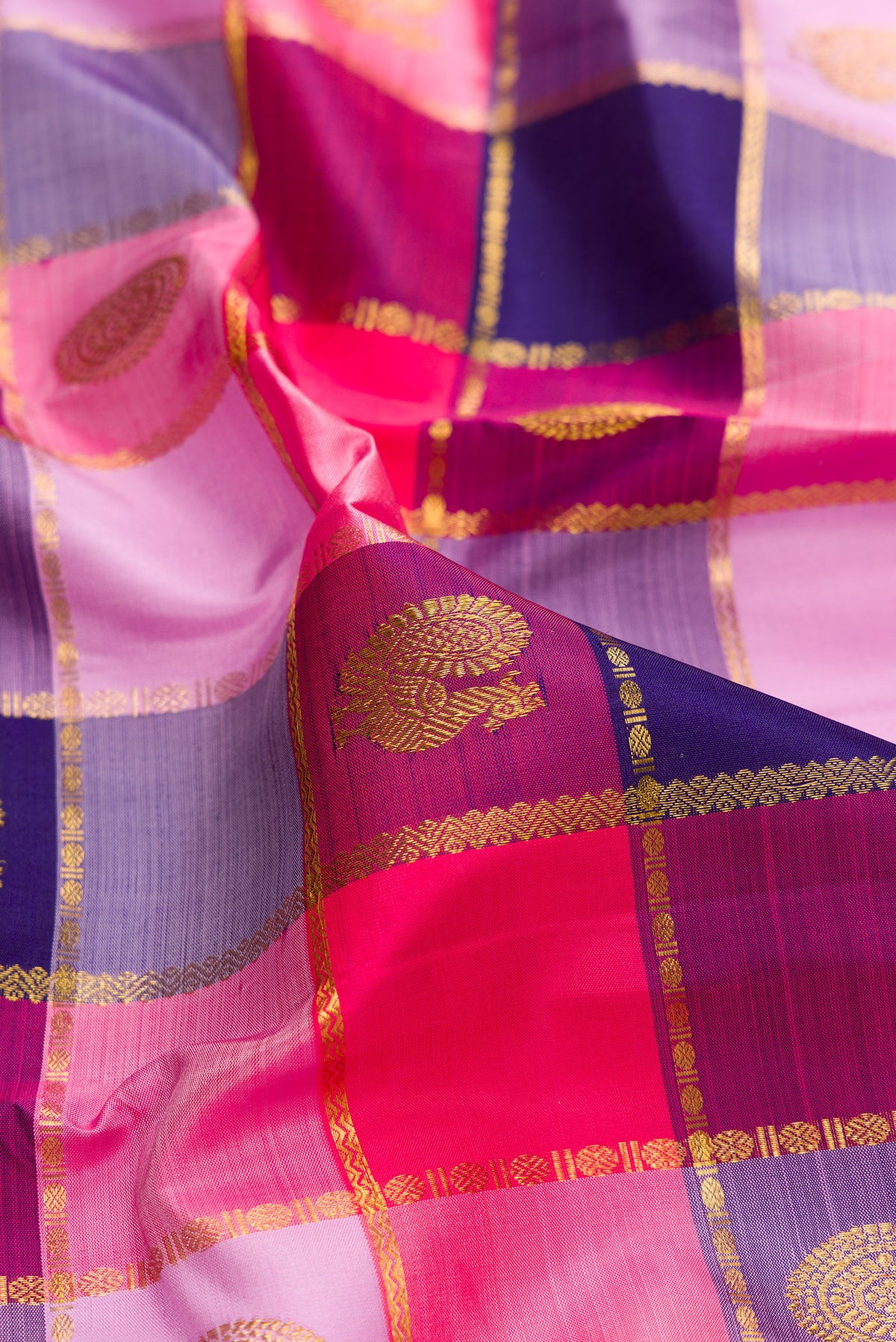 Close up of Pure Silk Multi Color Kanjivaram Saree with Checked design on the body and Zari Border.  displaying folds