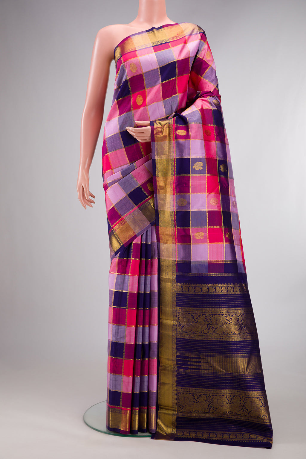 Pure Silk Multi Color Kanjivaram Saree with Checked design on the body and Zari Border.  displayed on a mannequin