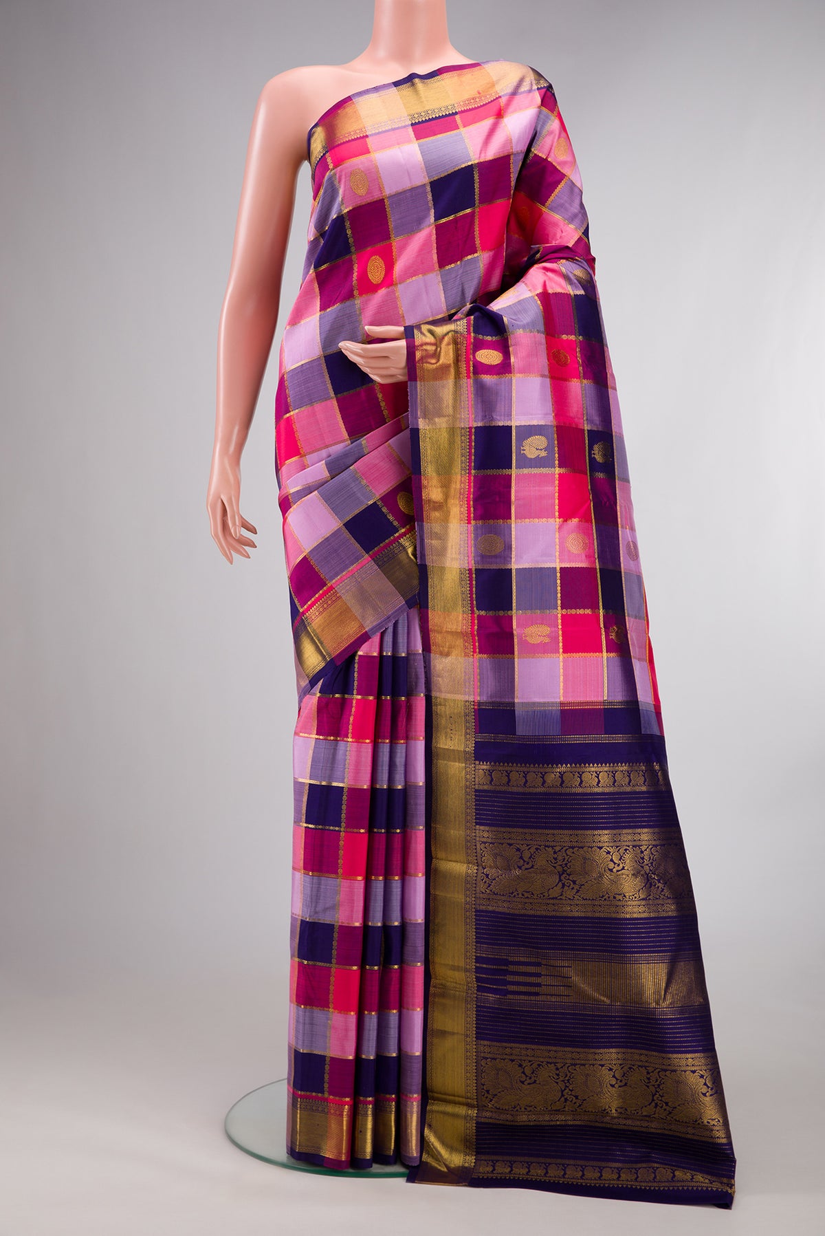 Pure Silk Multi Color Kanjivaram Saree with Checked design on the body and Zari Border.  displayed on a mannequin