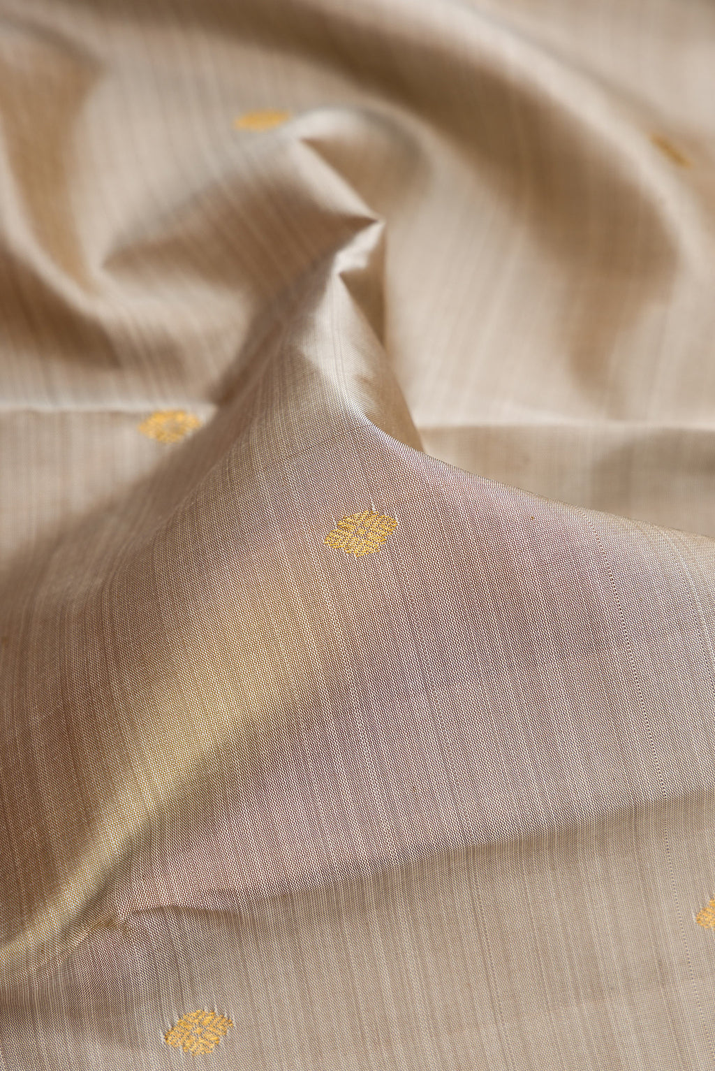 Close up of Pure Silk Grey Kanjivaram Saree with Zari Butta on the body and Zari Border.  displaying folds
