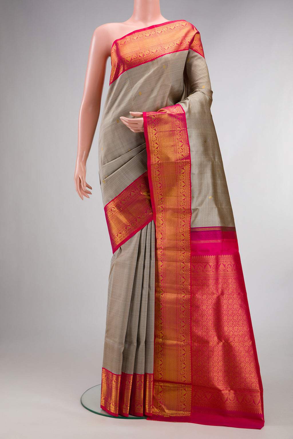 Pure Silk Grey Kanjivaram Saree with Zari Butta on the body and Zari Border.  displayed on a mannequin
