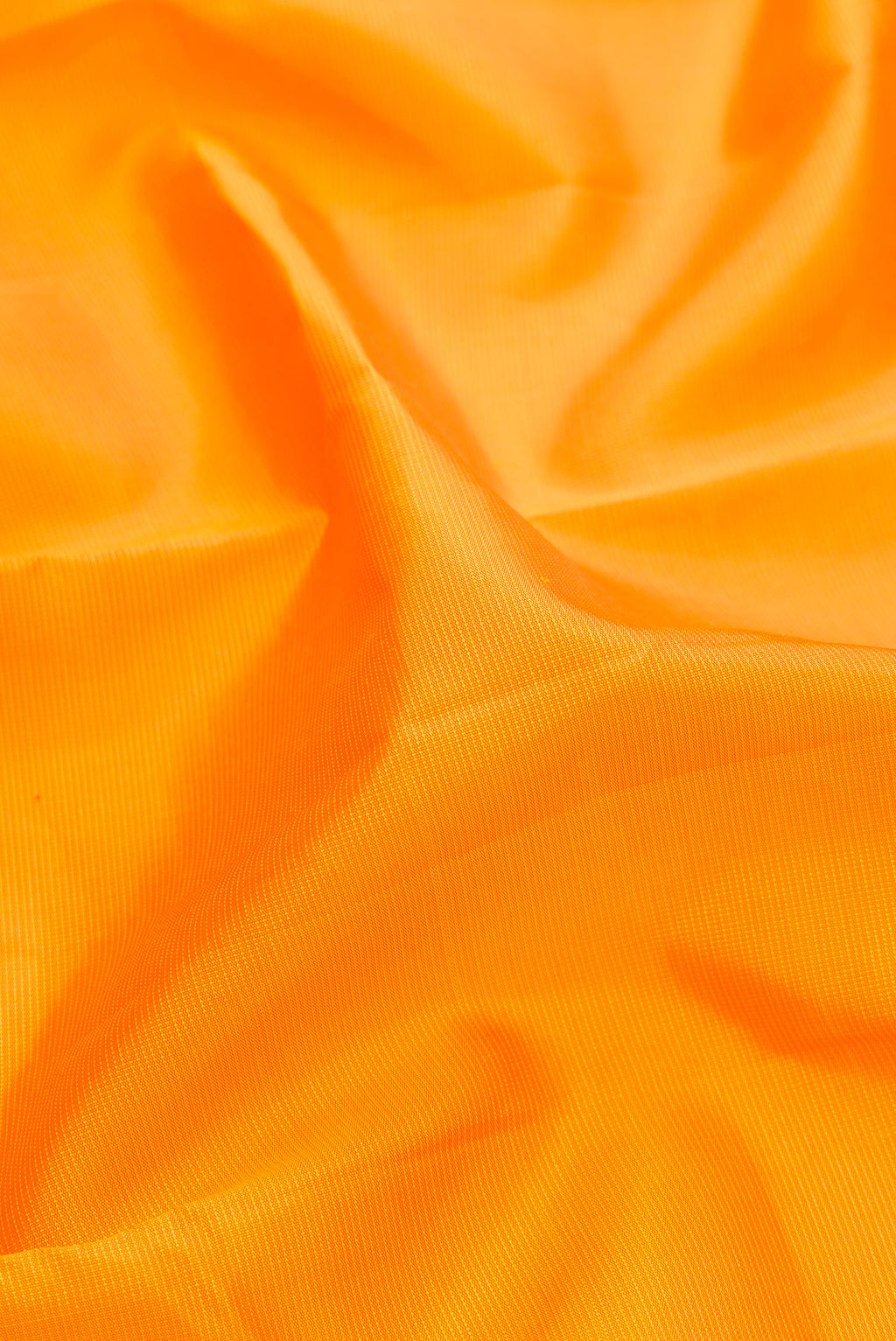 Close up of Pure Silk Yellow Kanjivaram Saree with Stripes on the body and Temple Border.  displaying folds