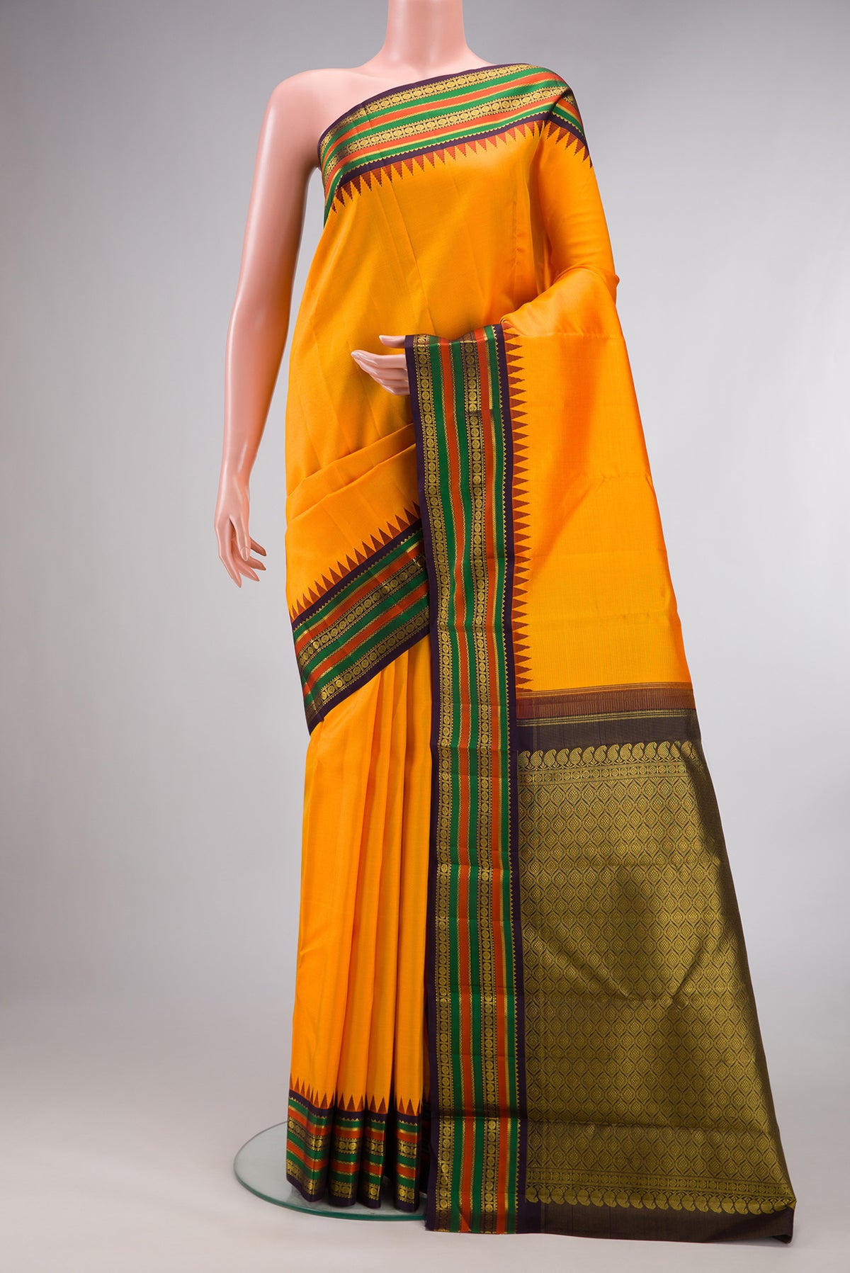 Pure Silk Yellow Kanjivaram Saree with Stripes on the body and Temple Border.  displayed on a mannequin