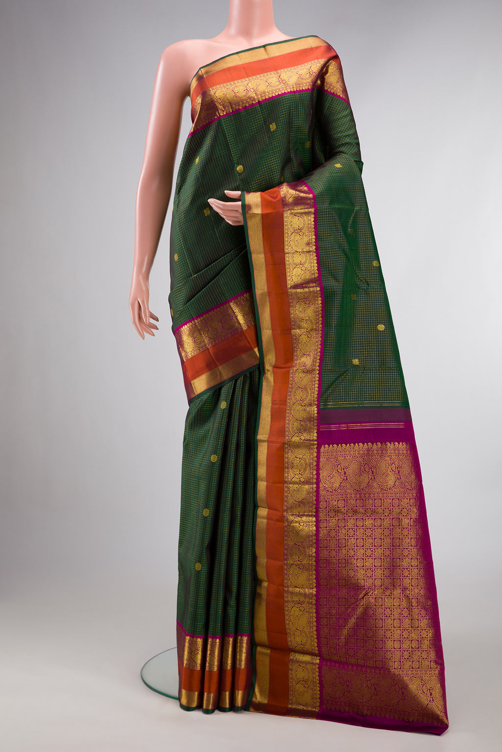 Pure Silk Green Kanjivaram Saree with Checked design on the body and Zari Border.  displayed on a mannequin