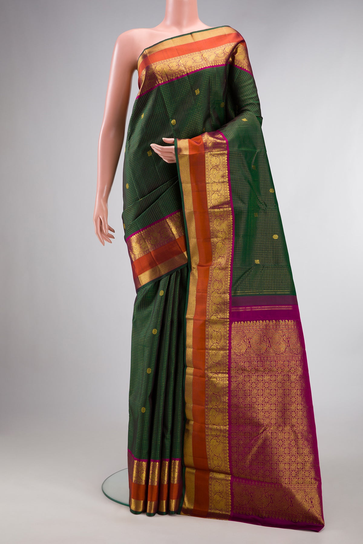 Pure Silk Green Kanjivaram Saree with Checked design on the body and Zari Border.  displayed on a mannequin