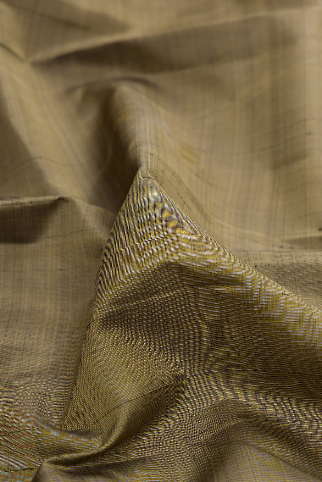 Close up of Pure Silk Green Kanjivaram Saree with Plain Body and Zari Border.  displaying folds