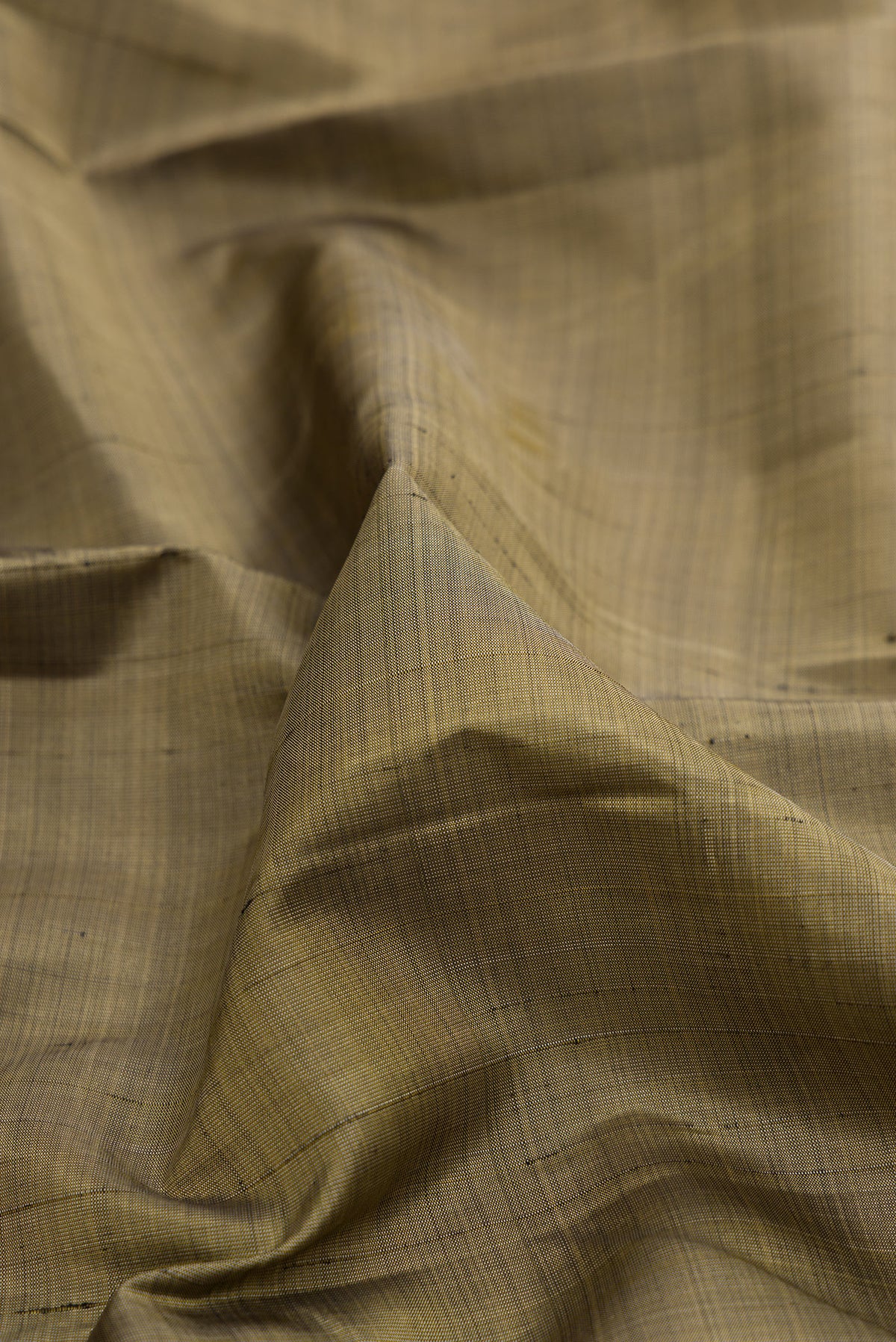 Close up of Pure Silk Green Kanjivaram Saree with Plain Body and Zari Border.  displaying folds