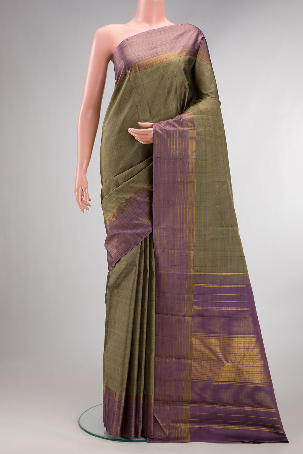Pure Silk Green Kanjivaram Saree with Plain Body and Zari Border.  displayed on a mannequin