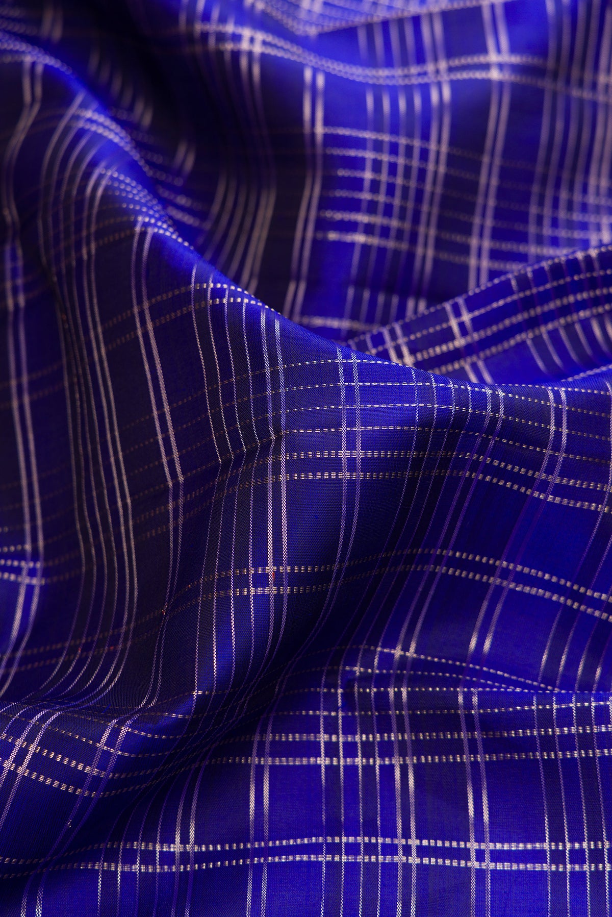 Close up of Pure Silk Royal Blue Kanjivaram Saree with Checked design on the body and Fancy Border.  displaying folds
