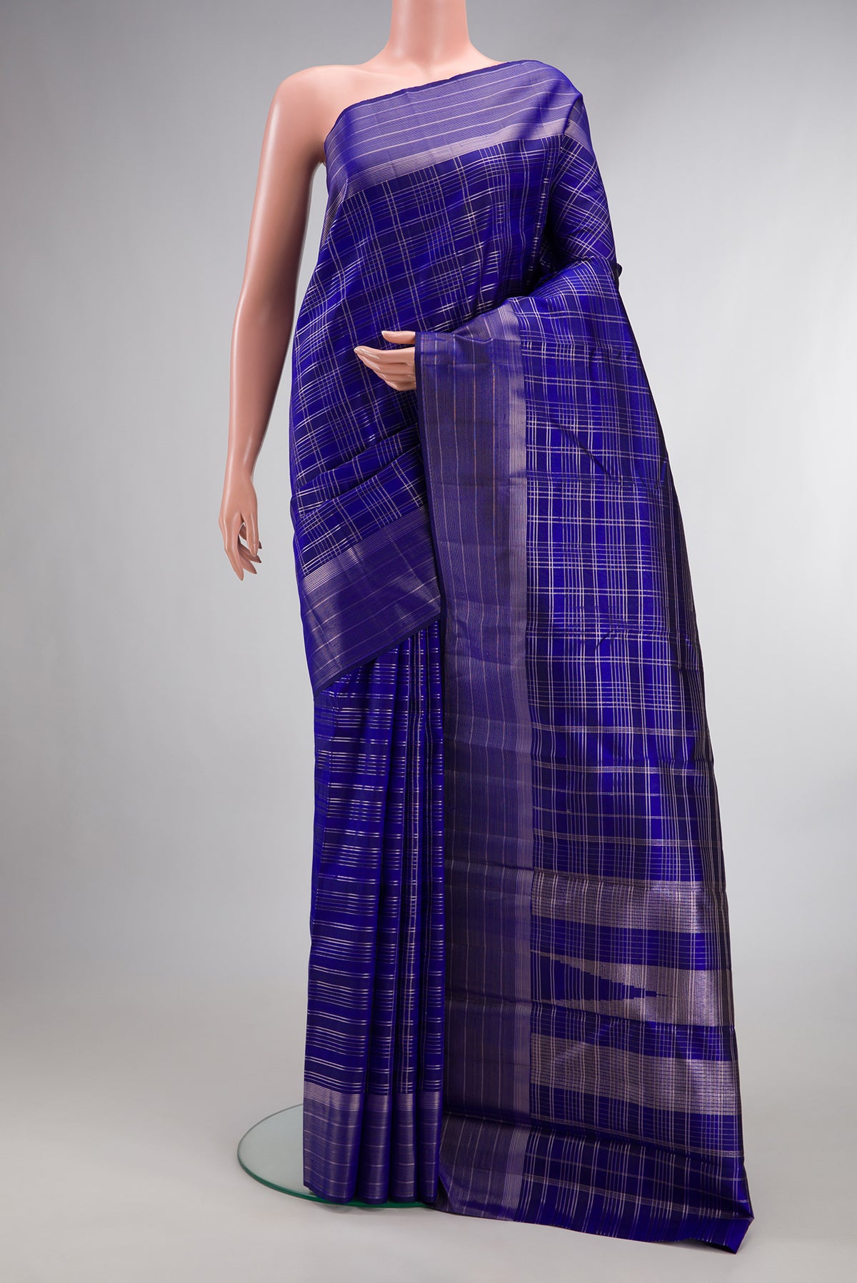 Pure Silk Royal Blue Kanjivaram Saree with Checked design on the body and Fancy Border.  displayed on a mannequin