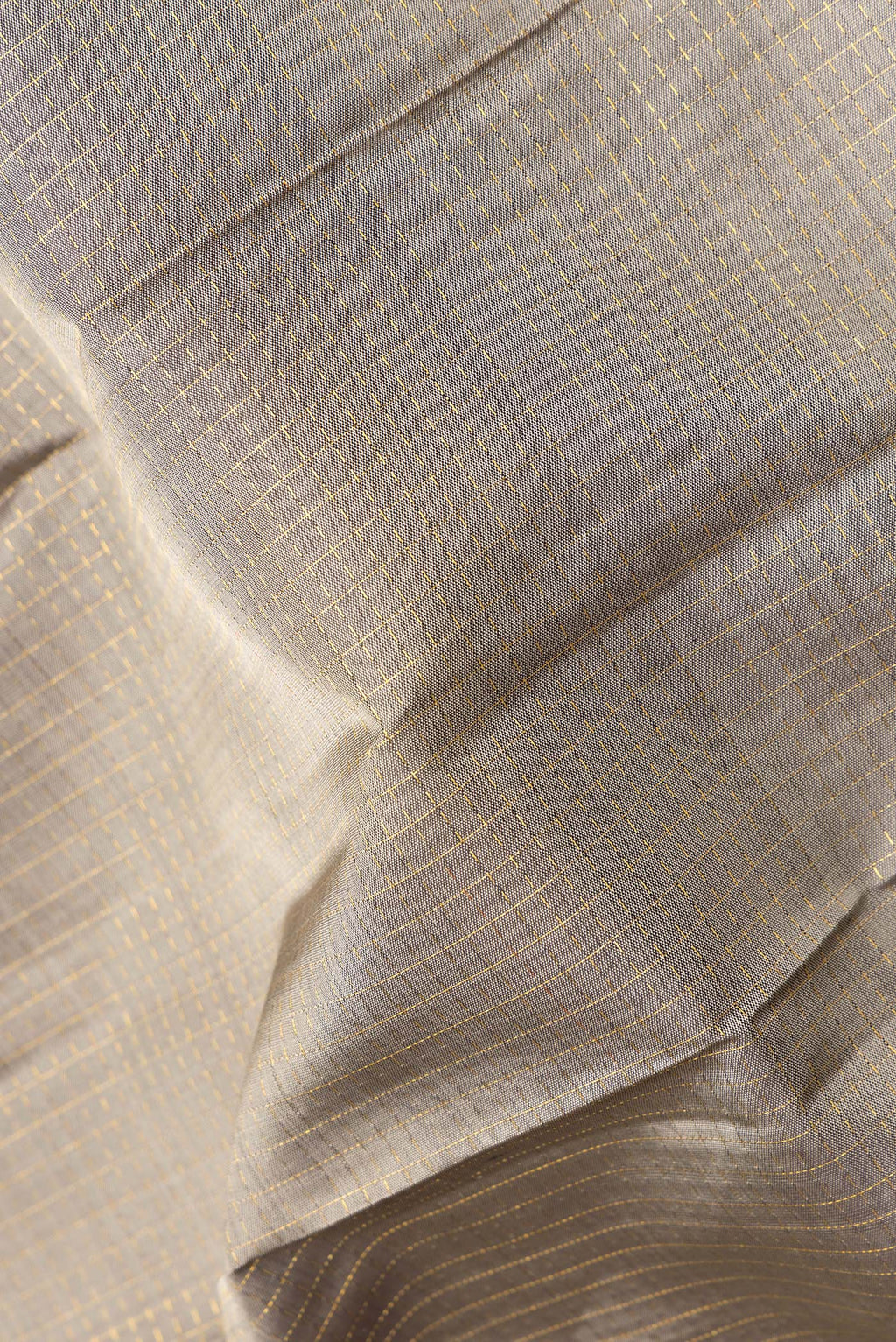 Close up of Pure Silk Grey Kanjivaram Saree with Checked design on the body and Zari Border.  displaying folds