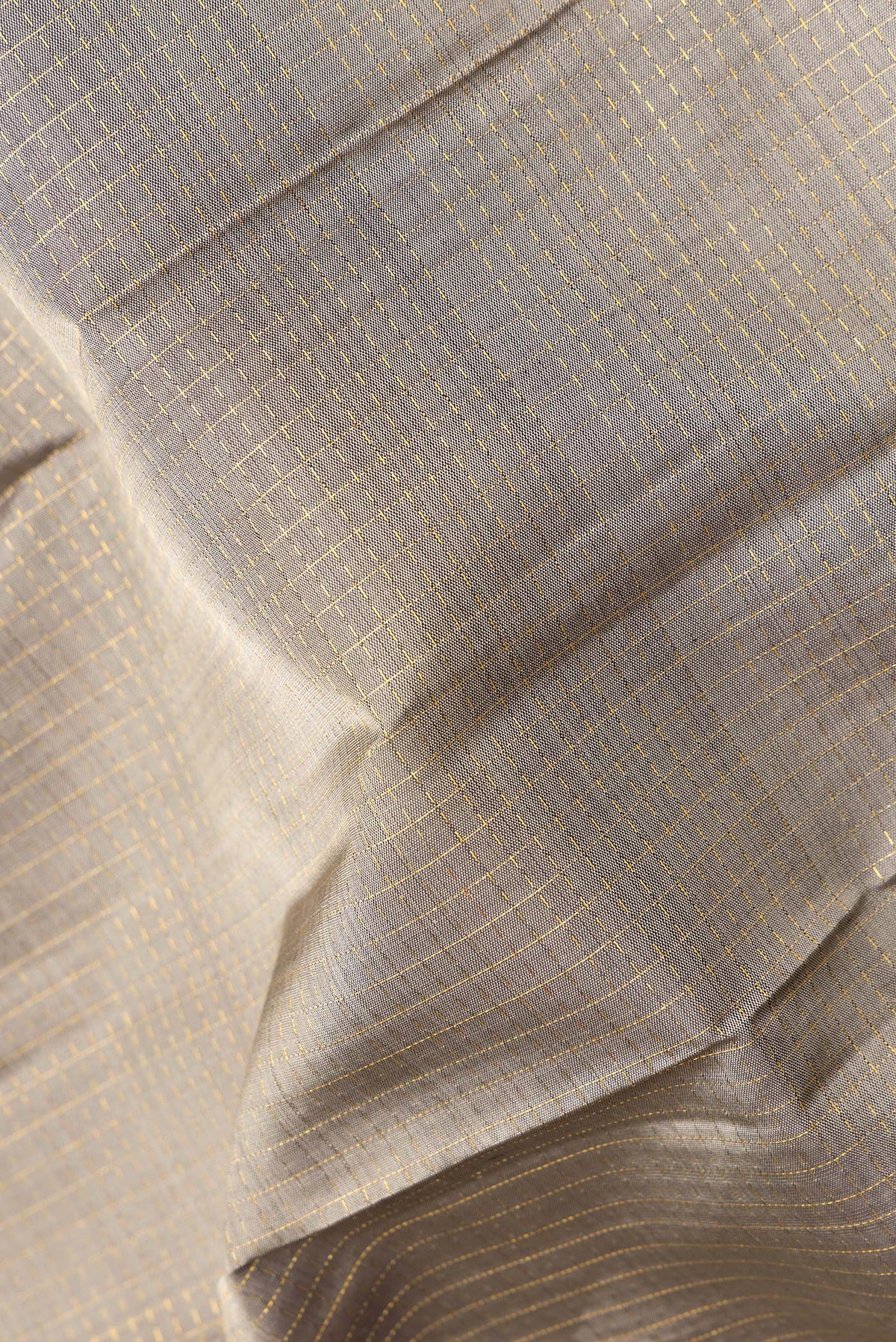 Close up of Pure Silk Grey Kanjivaram Saree with Checked design on the body and Zari Border.  displaying folds