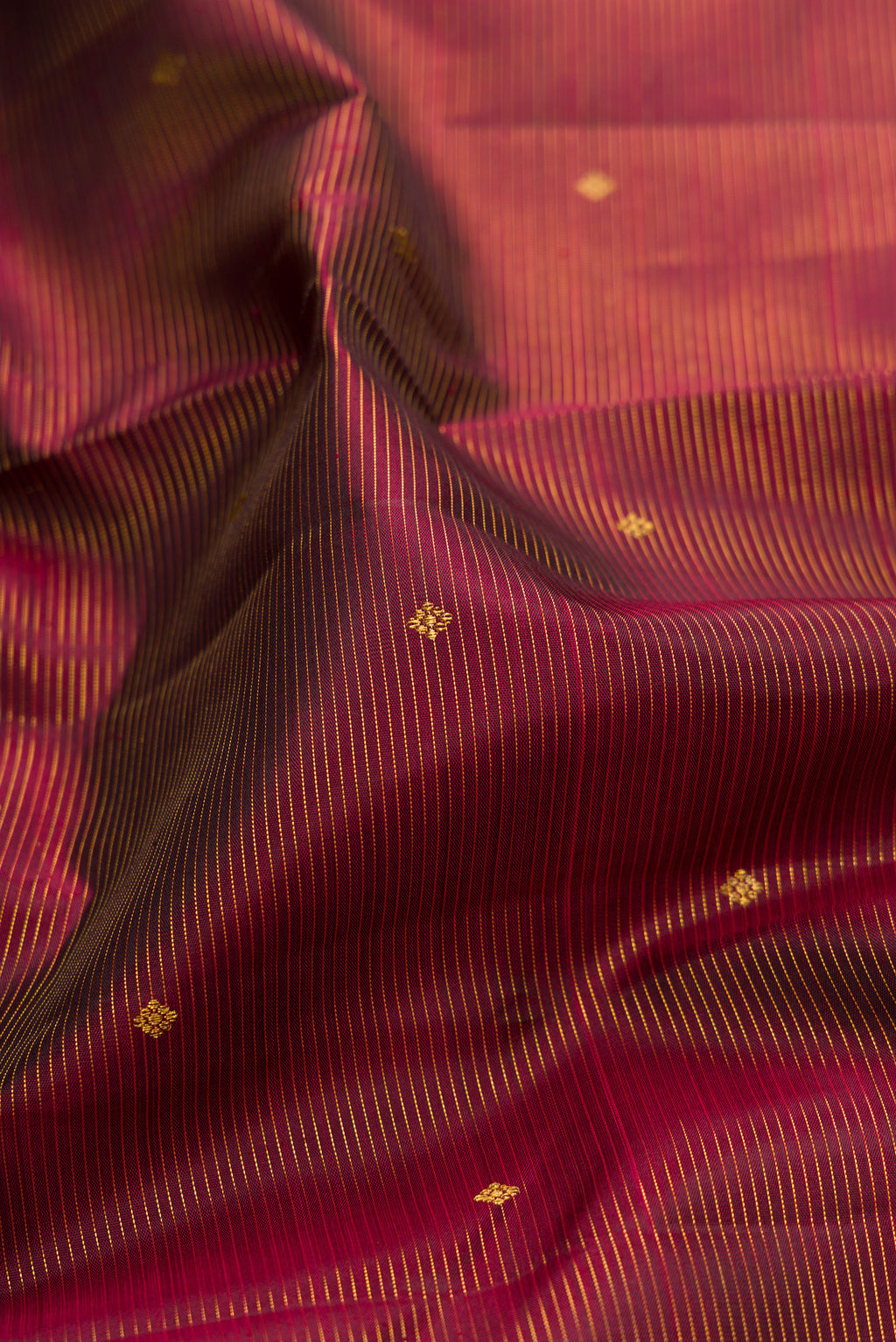 Close up of Pure Silk Maroon Kanjivaram Saree with Stripes on the body and Zari Border.  displaying folds