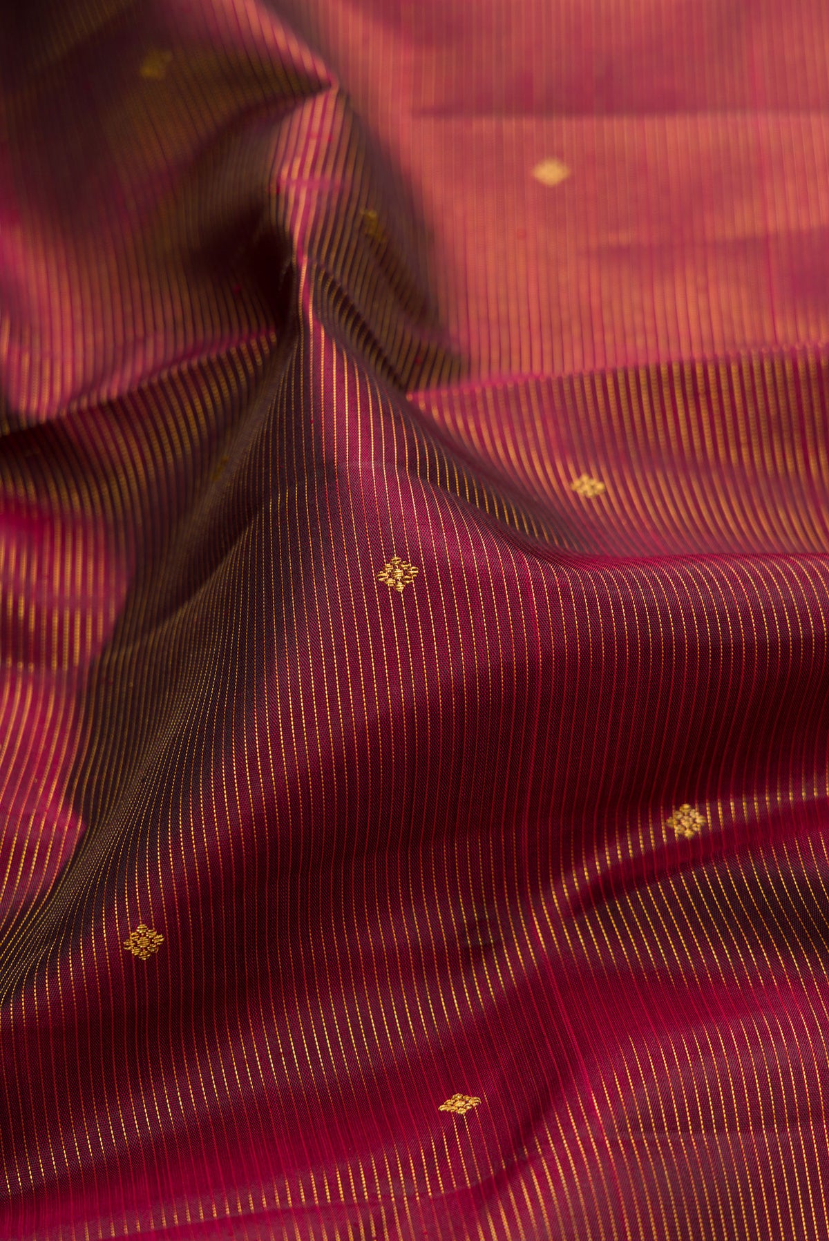 Close up of Pure Silk Maroon Kanjivaram Saree with Stripes on the body and Zari Border.  displaying folds