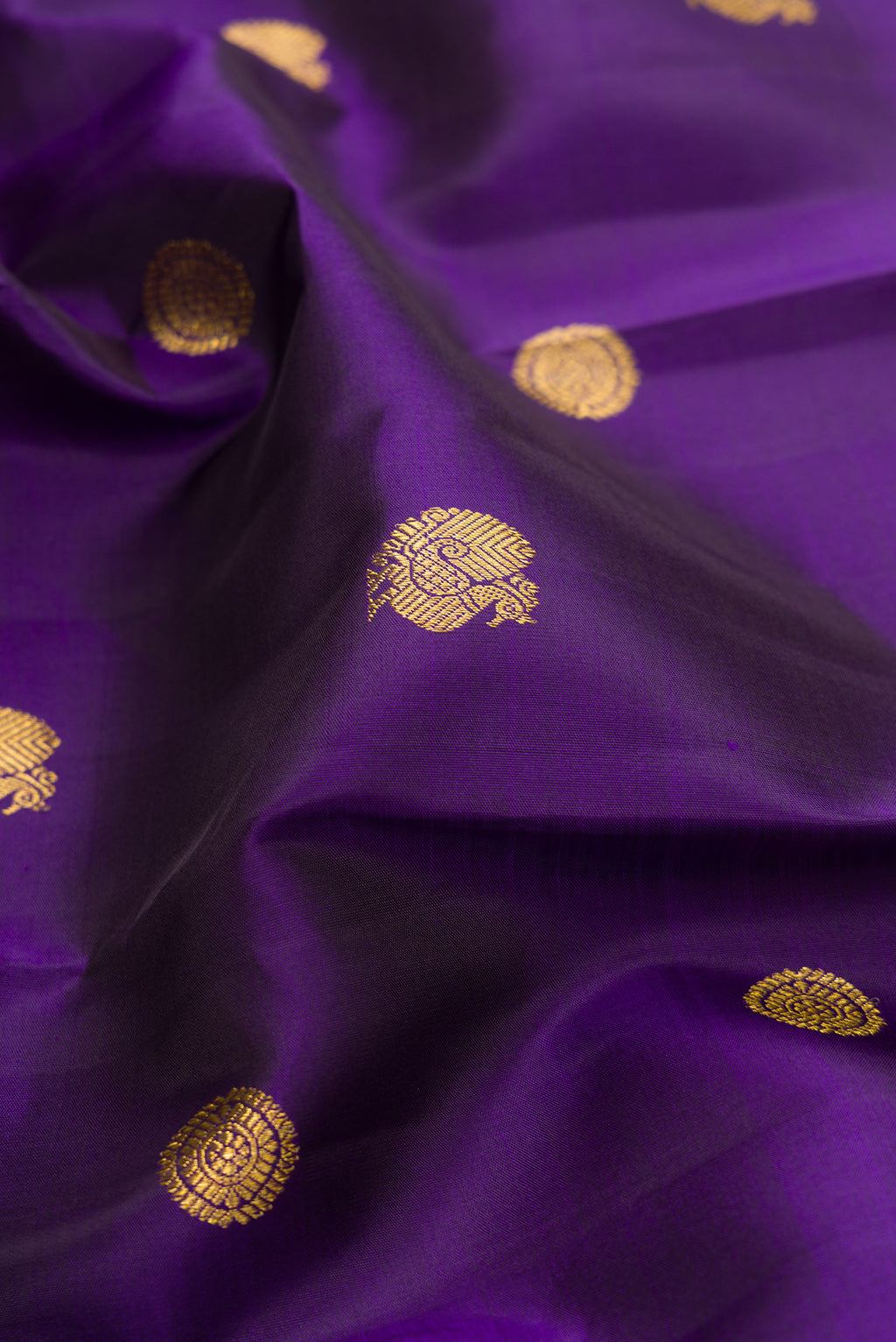 Close up of Pure Silk Violet Kanjivaram Saree with Zari Butta on the body and Zari Border.  displaying folds