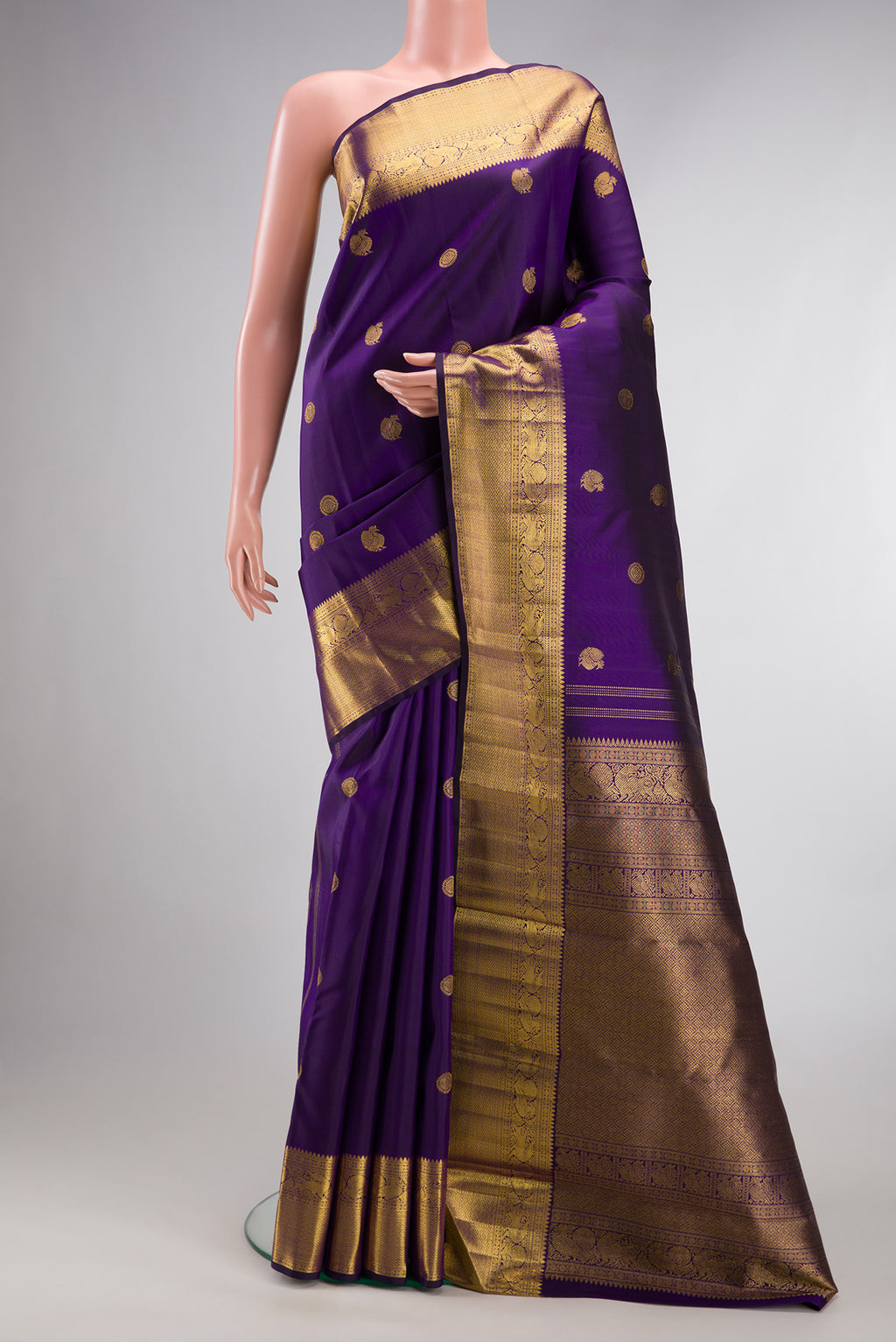 Pure Silk Violet Kanjivaram Saree with Zari Butta on the body and Zari Border.  displayed on a mannequin