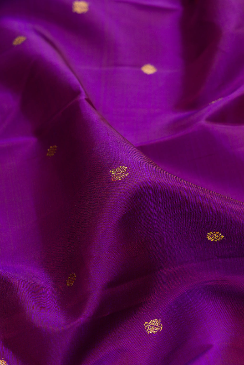 Close up of Pure Silk Purple Kanjivaram Saree with Zari Butta on the body and Zari Border.  displaying folds