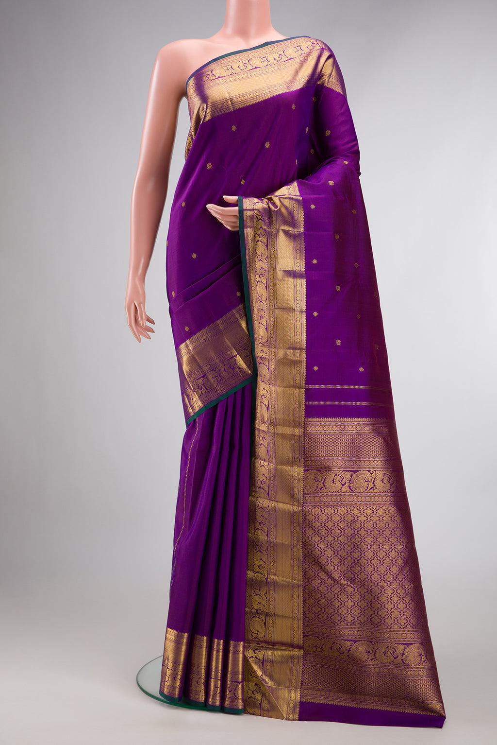 Pure Silk Purple Kanjivaram Saree with Zari Butta on the body and Zari Border.  displayed on a mannequin
