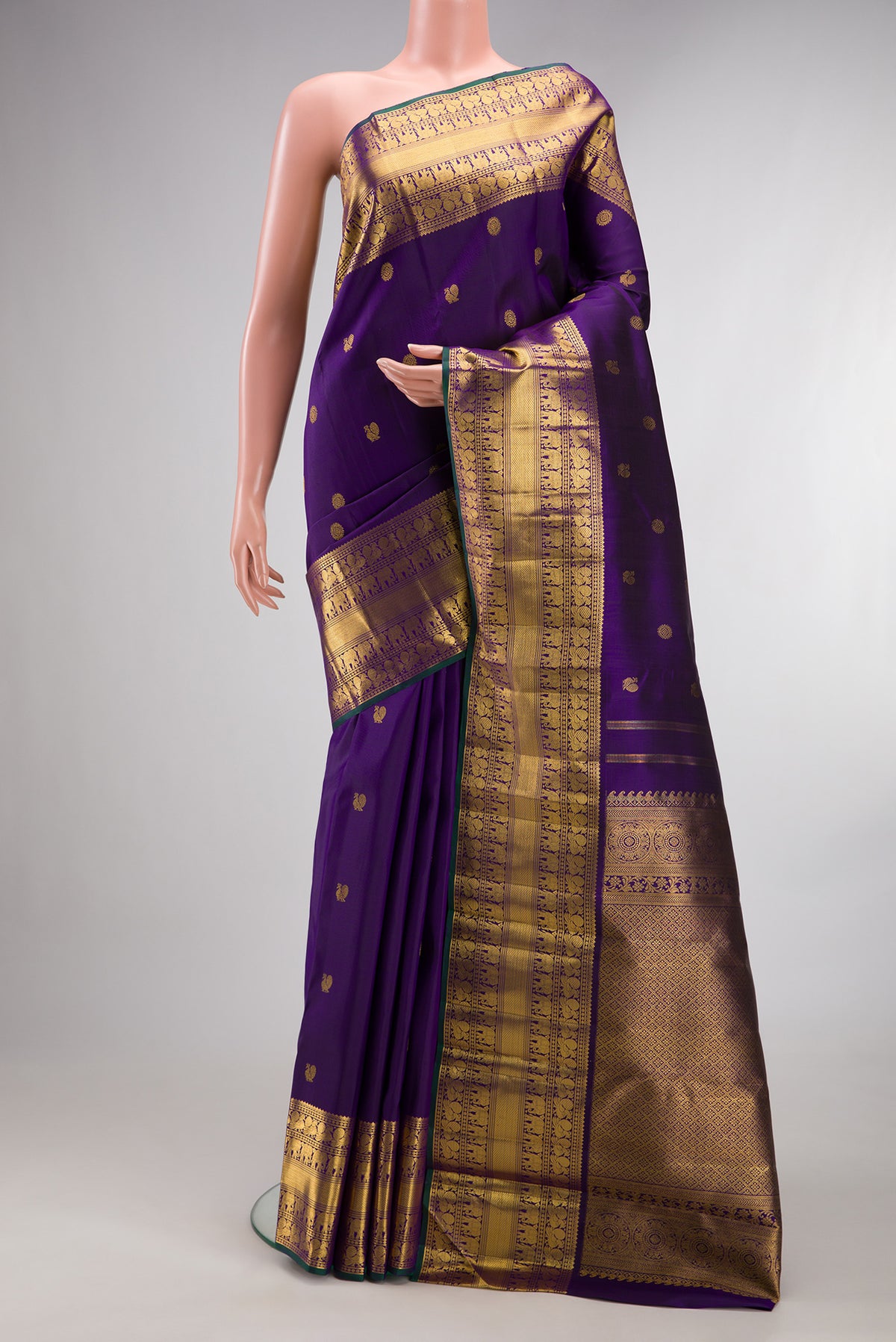 Pure Silk Violet Kanchipuram Saree with Zari Butta on the body and Zari Border.  displayed on a mannequin