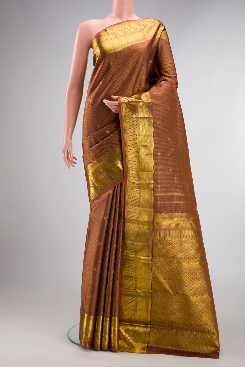 Pure Silk Brown Kanchipuram Saree with Zari Butta on the body and Zari Border.  displayed on a mannequin
