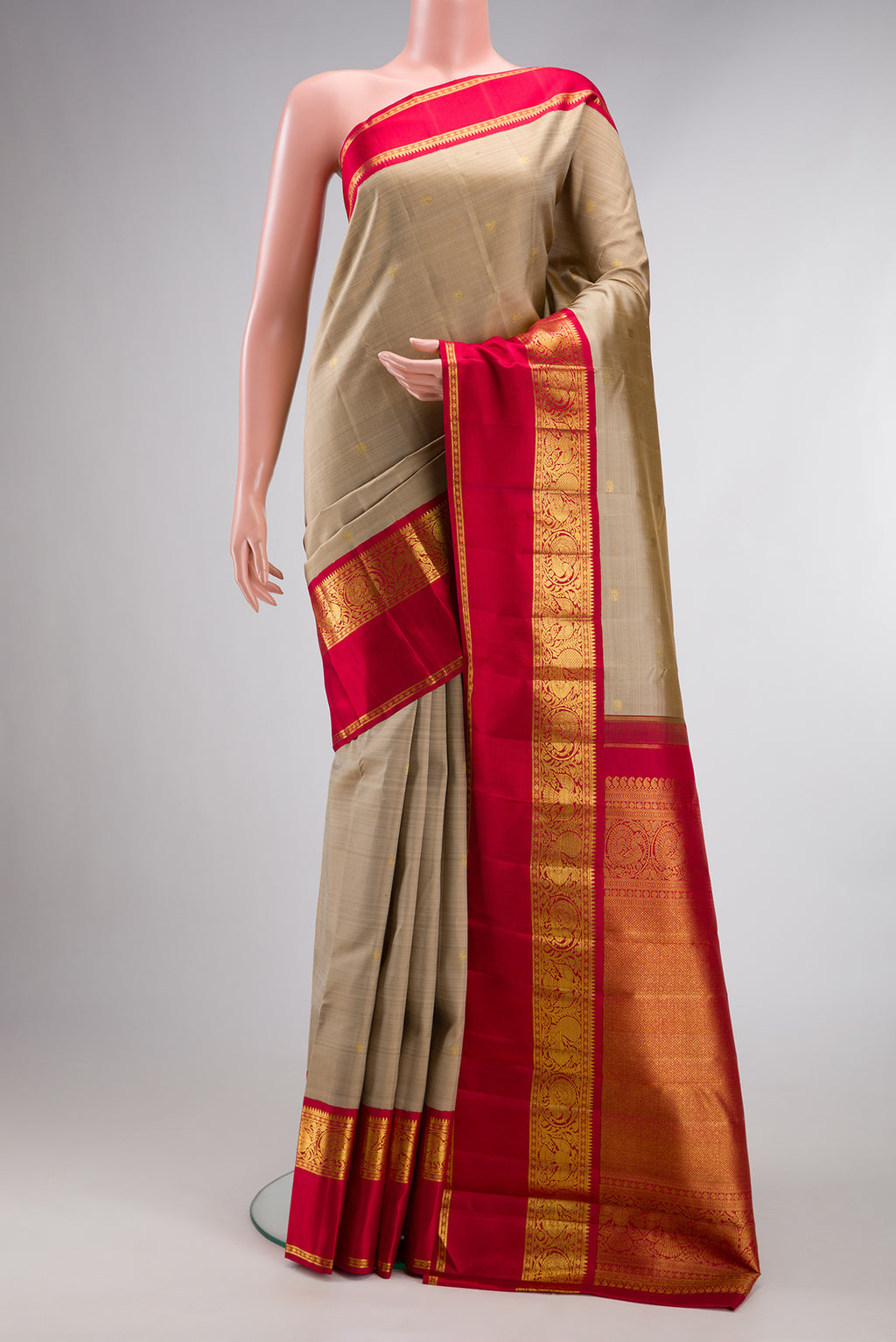 Pure Silk Dark Beige Kanchipuram Saree with Zari Butta on the body and Zari And Thread Border.  displayed on a mannequin