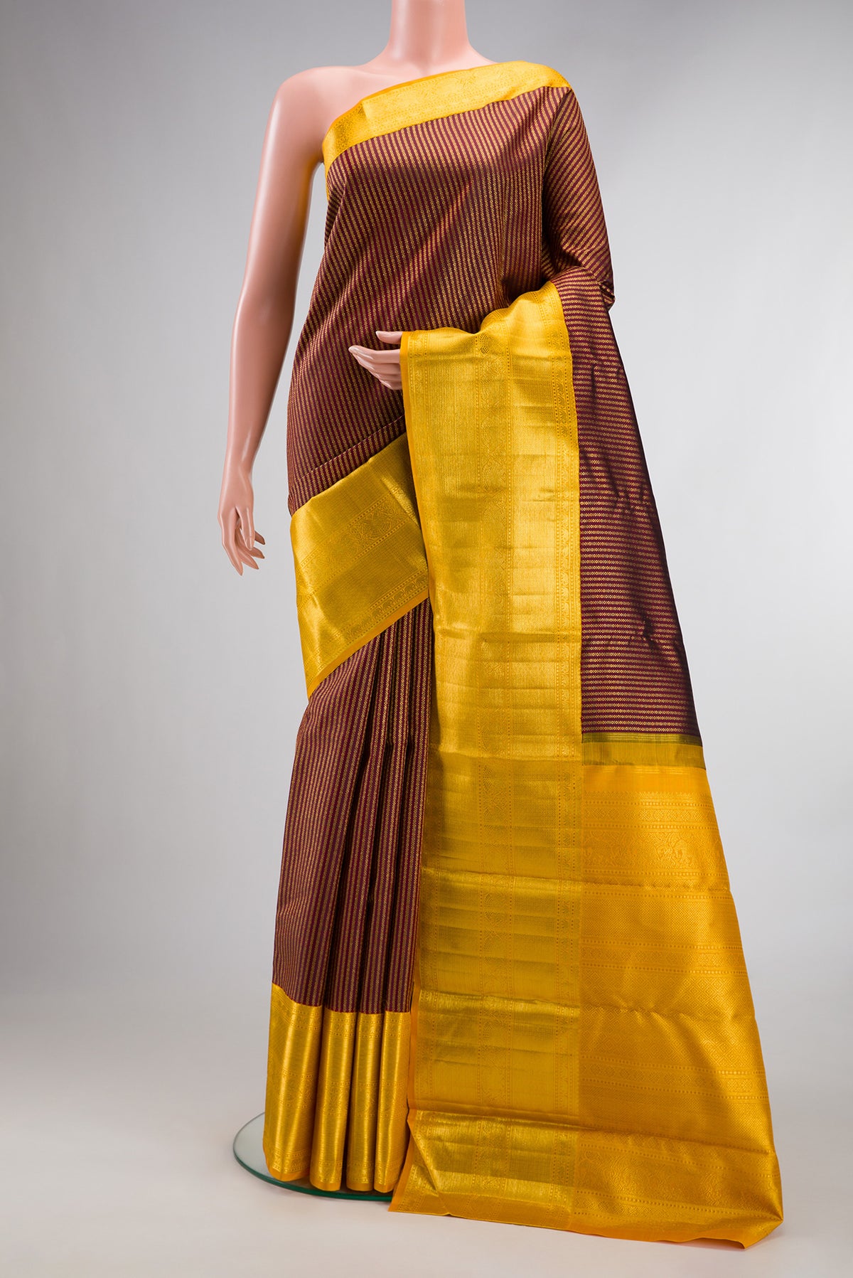 Pure Silk Coffee Brown Kanchipuram Saree with Zari Brocade on the body and Zari Border.  displayed on a mannequin