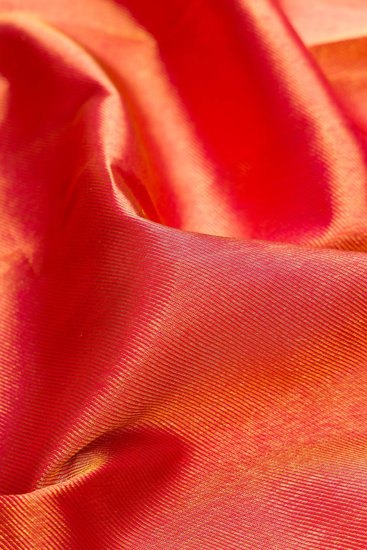 Close up of Pure Silk Dark Pink Kanchipuram Saree with Zari Brocade on the body and Zari Border.  displaying folds