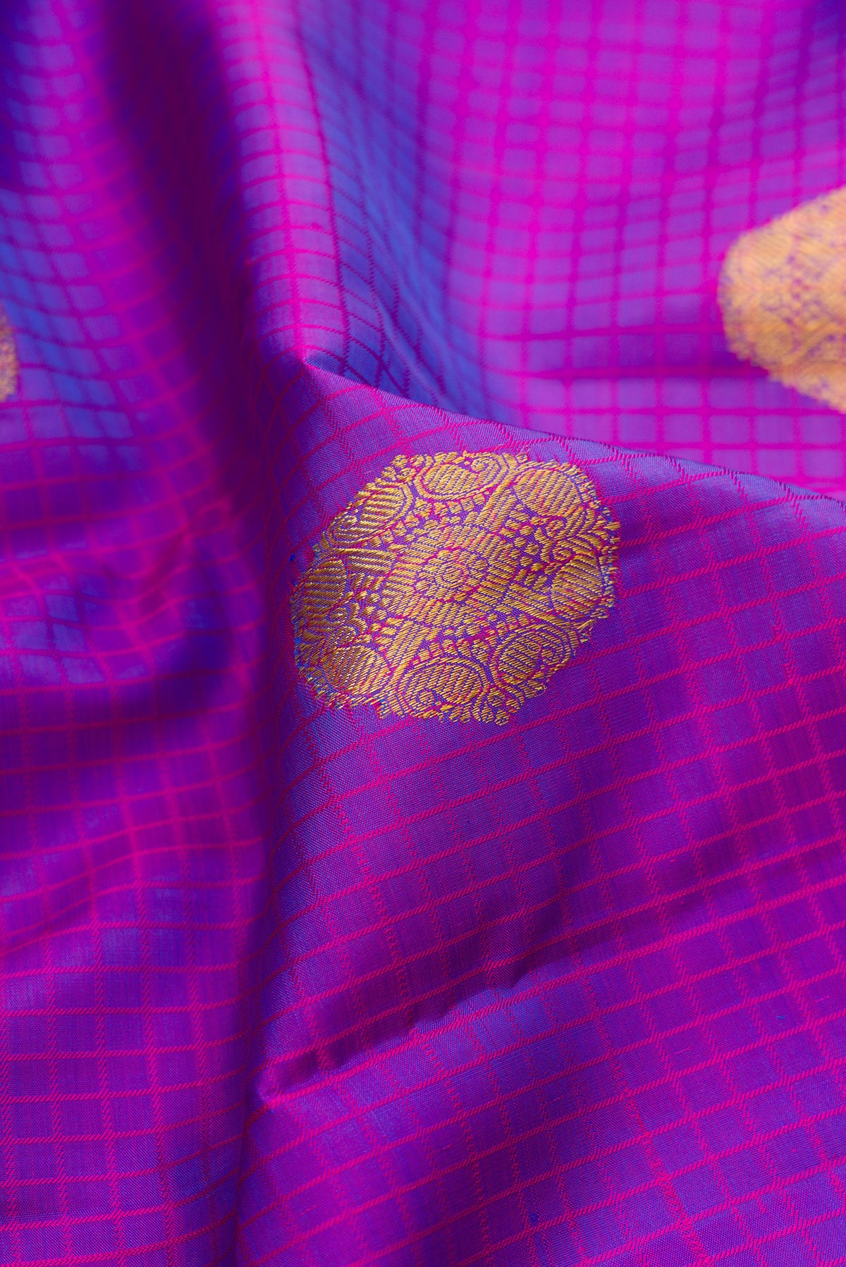 Close up of Pure Silk Purple Kanchipuram Saree with Checked design on the body and Zari Border.  displaying folds