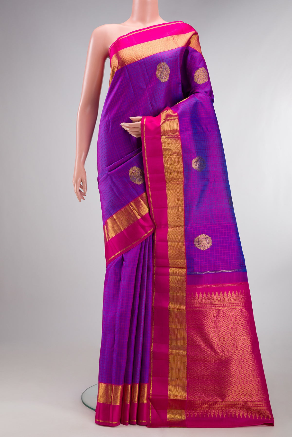 Pure Silk Purple Kanchipuram Saree with Checked design on the body and Zari Border.  displayed on a mannequin