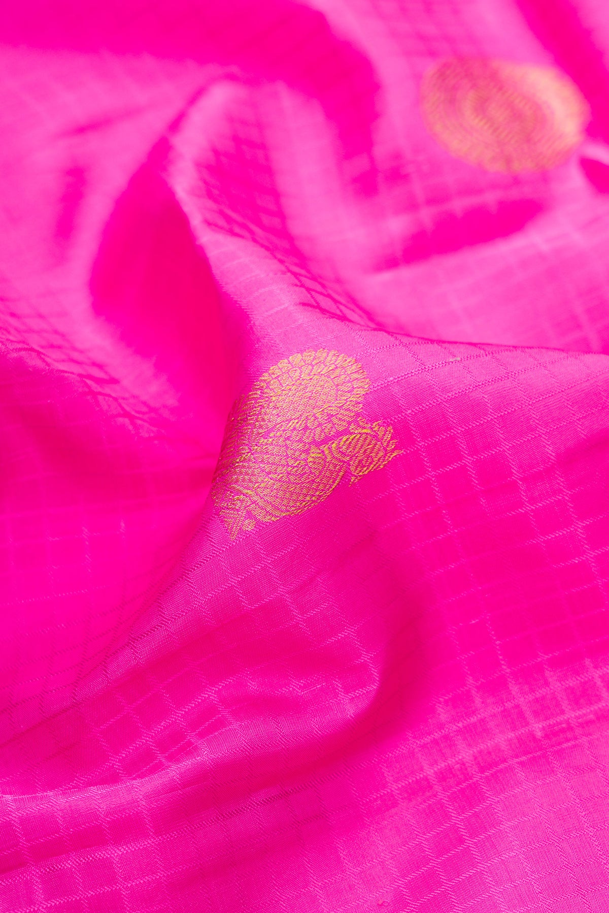 Close up of Pure Silk Pink Kanchipuram Saree with Jacquard With Zari Butta on the body and Zari Border.  displaying folds