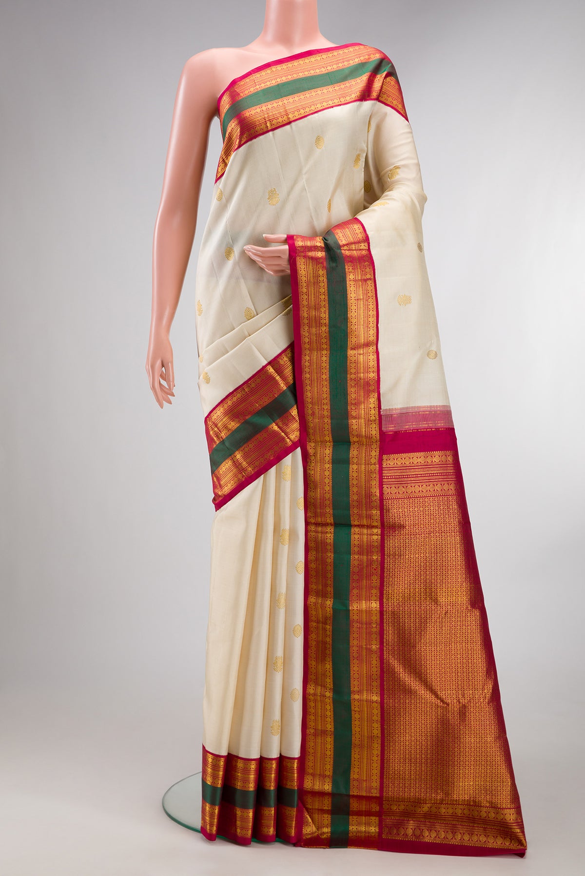 Pure Silk Cream Kanjivaram Saree with Zari Butta on the body and Fancy Border.  displayed on a mannequin