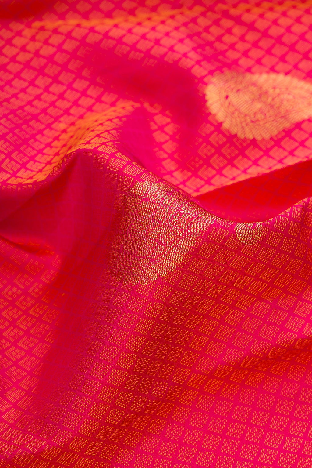 Close up of Pure Silk Dark Pink Dual Tone Kanchipuram Saree with Jacquard With Zari Butta on the body and Fancy Border.  displaying folds