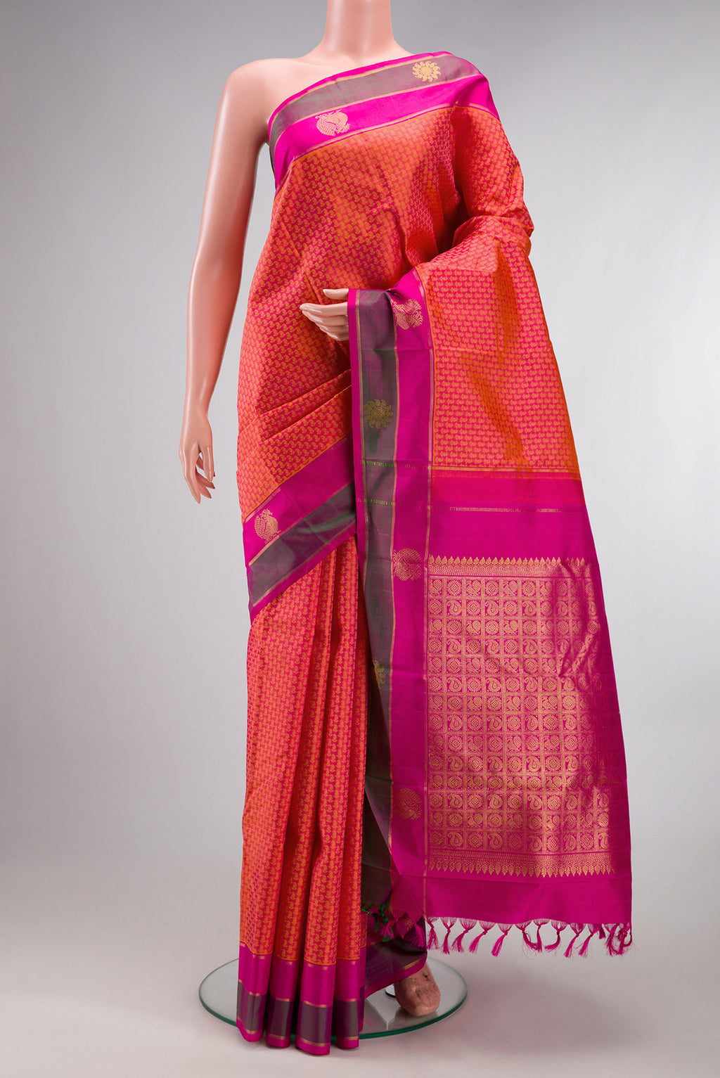 Pure Silk Orange Dual Tone Kanjivaram Saree with Jacquard design on the body and Fancy Border.  displayed on a mannequin