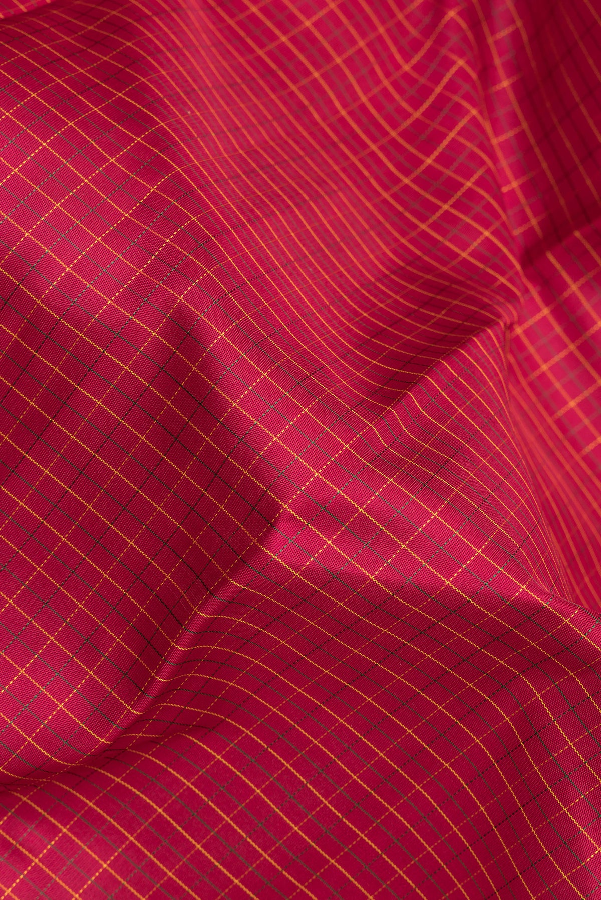 Close up of Pure Silk Deep Red Kanchipuram Saree with Checked design on the body and Zari Border.  displaying folds