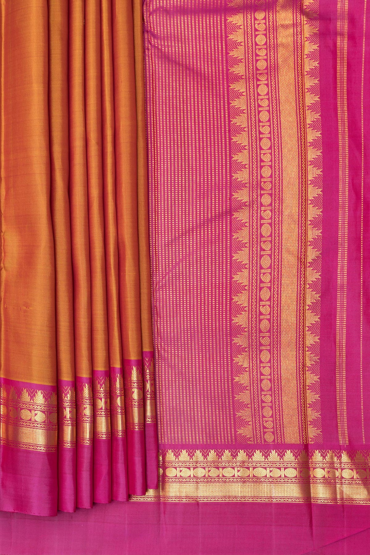 Pleats and pallu of Pure Silk Mustard Dual Tone Kanjivaram Saree with Zari Butta on the body and Zari Border. 