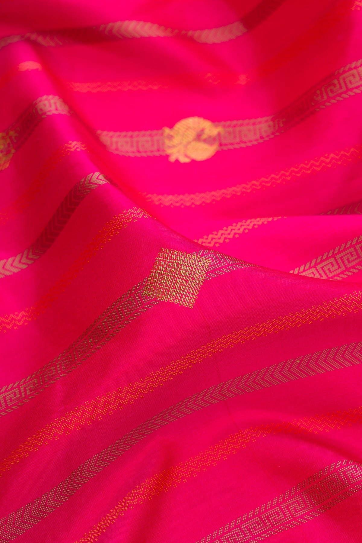 Close up of Pure Silk Dark Pink Dual Tone Kanjivaram Saree with Stripes on the body and Without Border.  displaying folds