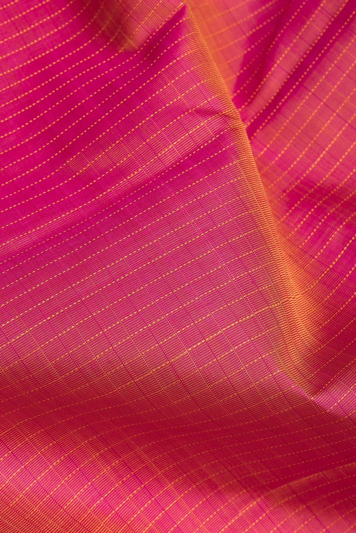Close up of Pure Silk Pink Dual Tone Kanchipuram Saree with Checked design on the body and Zari Border.  displaying folds