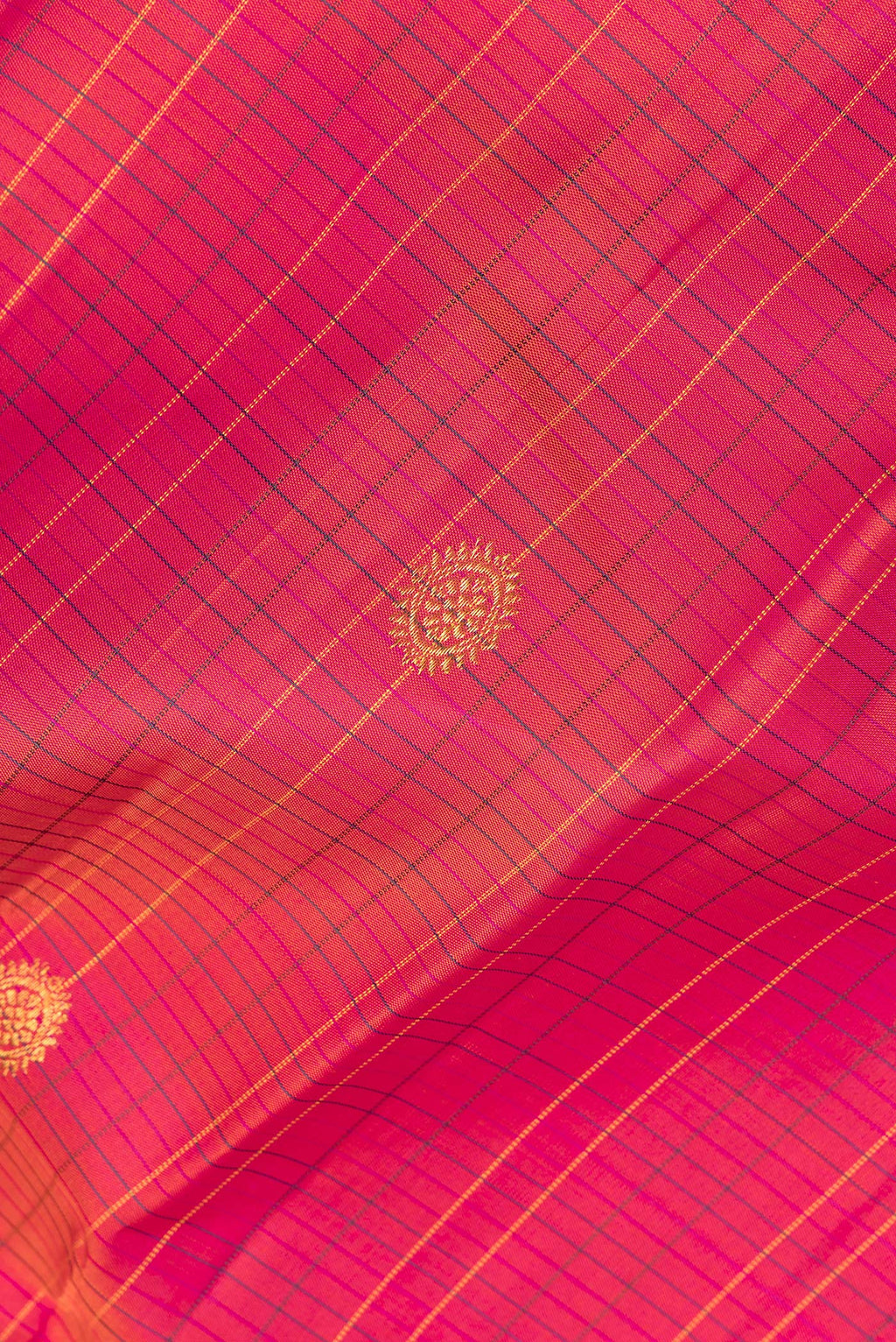 Close up of Pure Silk Coral Dual Tone Kanjivaram Saree with Checked design on the body and Zari Border.  displaying folds