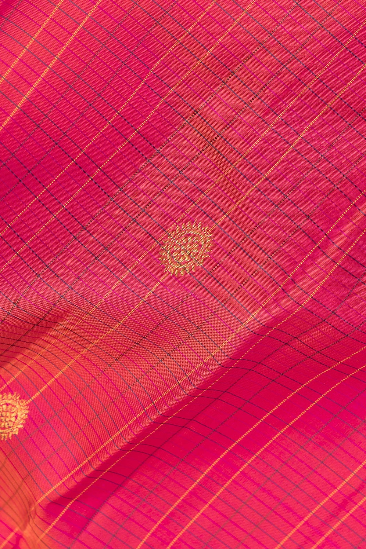 Close up of Pure Silk Coral Dual Tone Kanjivaram Saree with Checked design on the body and Zari Border.  displaying folds