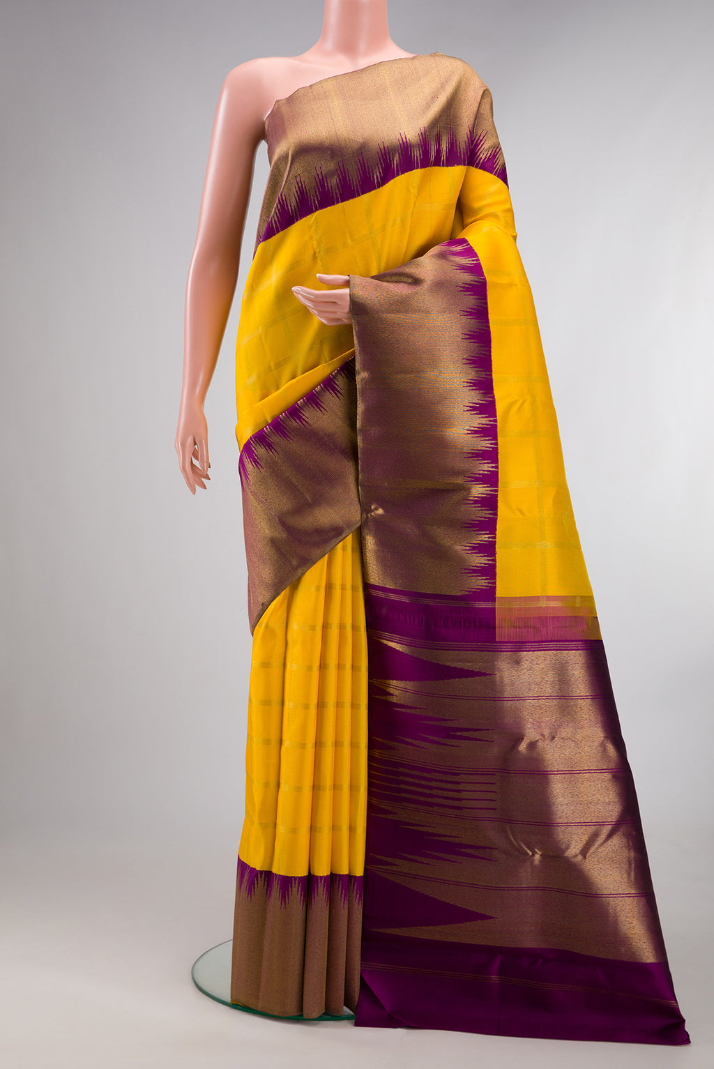 Pure Silk Pure Zari Yellow Kanjivaram Saree with Checked design on the body and Temple Border.  displayed on a mannequin