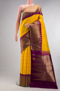 Pure Silk Pure Zari Yellow Kanjivaram Saree with Checked design on the body and Temple Border.  displayed on a mannequin