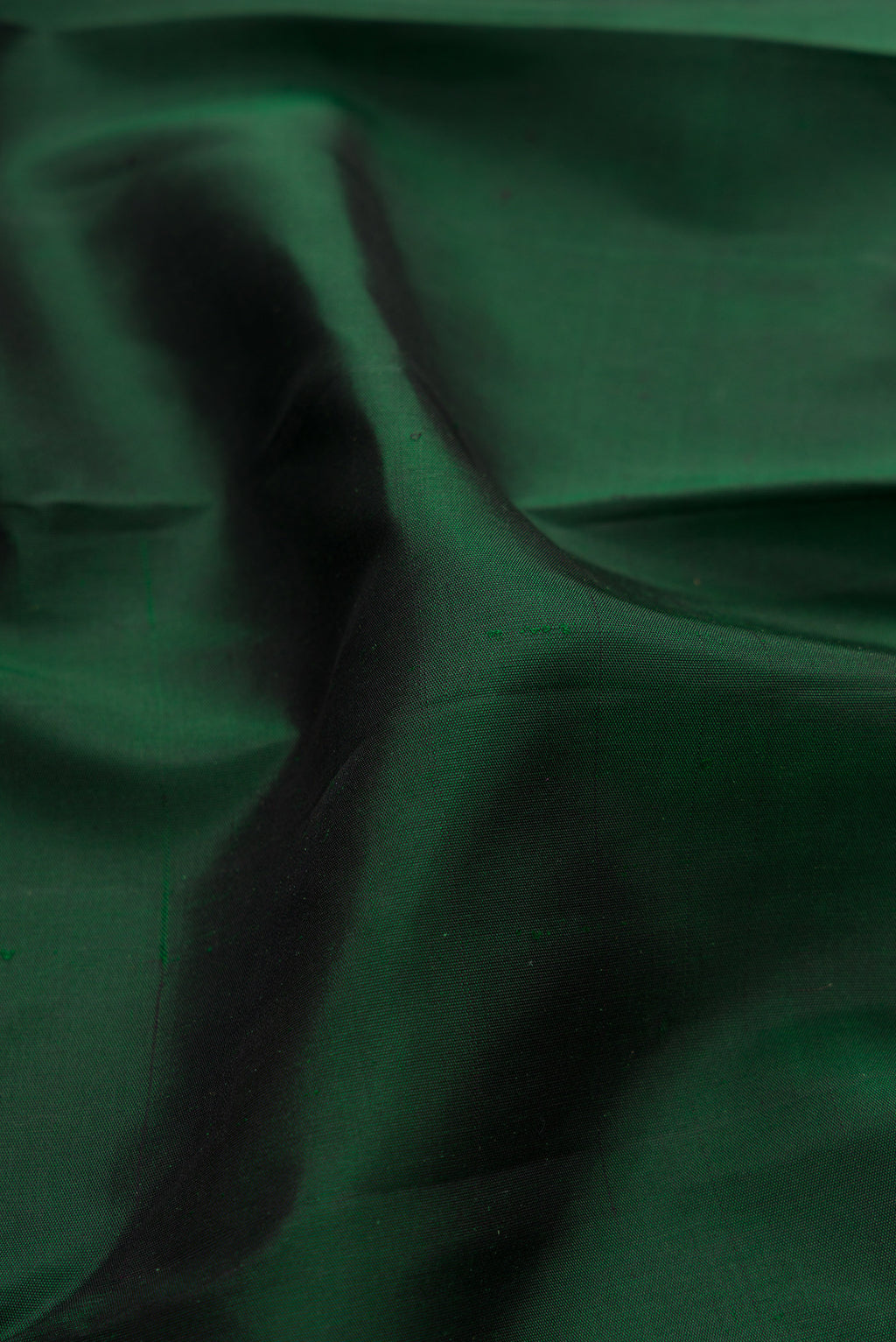Close up of Pure Silk Pure Zari Bottle Green Kanjivaram Saree with Plain Body and Temple Border.  displaying folds