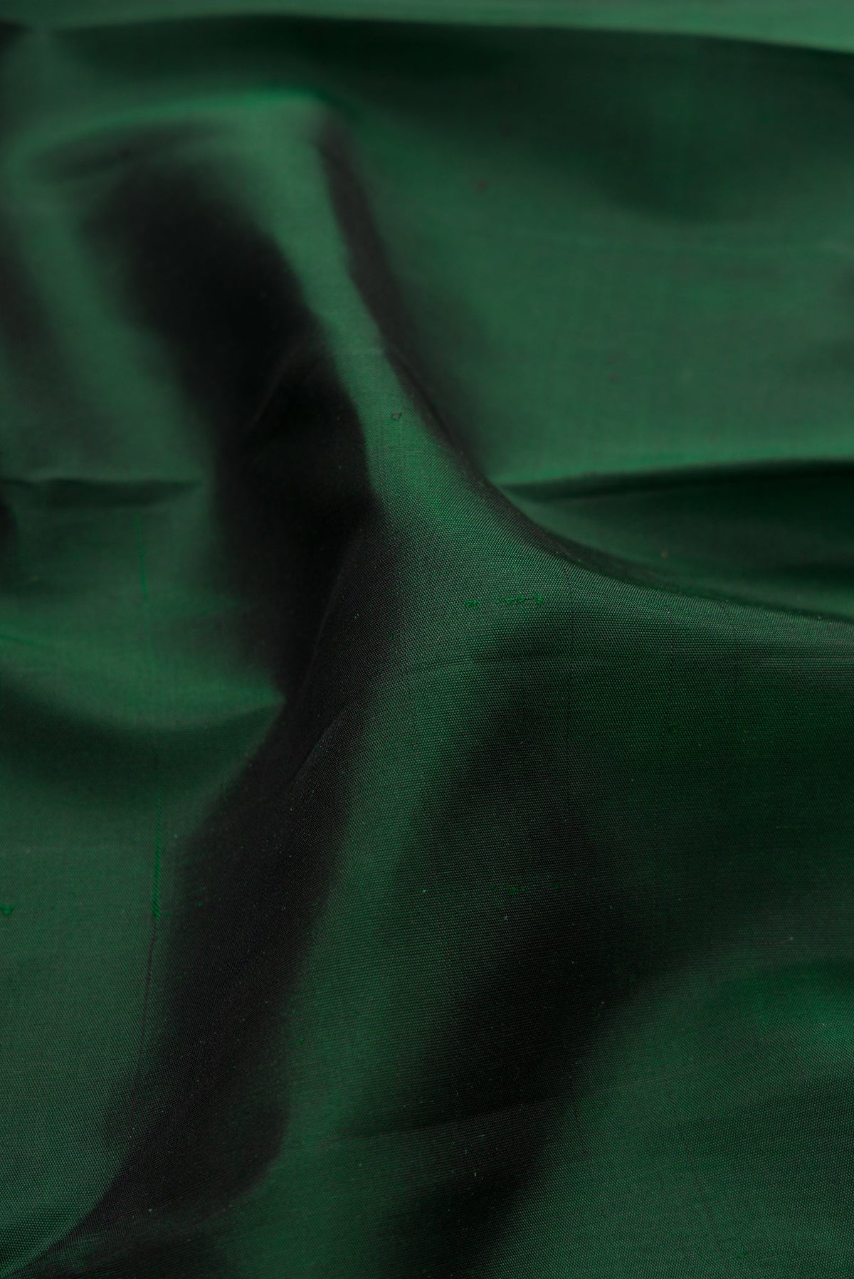Close up of Pure Silk Pure Zari Bottle Green Kanjivaram Saree with Plain Body and Temple Border.  displaying folds