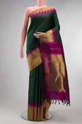 Pure Silk Pure Zari Bottle Green Kanjivaram Saree with Plain Body and Temple Border.  displayed on a mannequin
