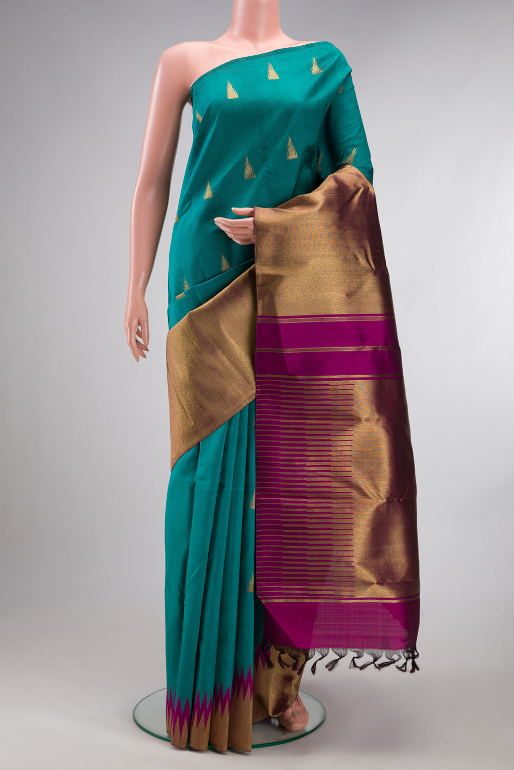 Pure Silk Pure Zari Teal Kanjivaram Saree with Zari Butta on the body and Rising Temple Border.  displayed on a mannequin