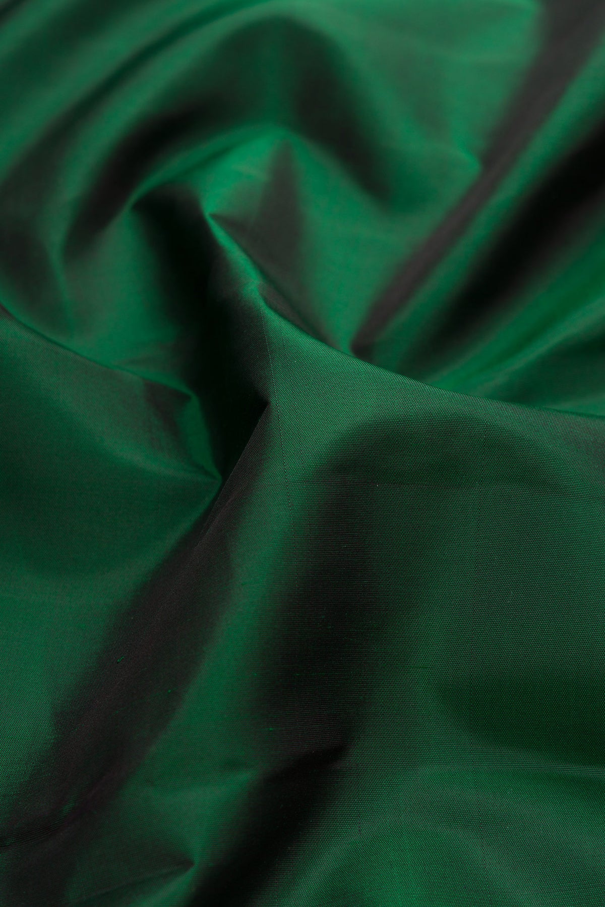 Close up of Pure Silk Bottle Green Kanchipuram Saree with Plain Body and Temple Border.  displaying folds