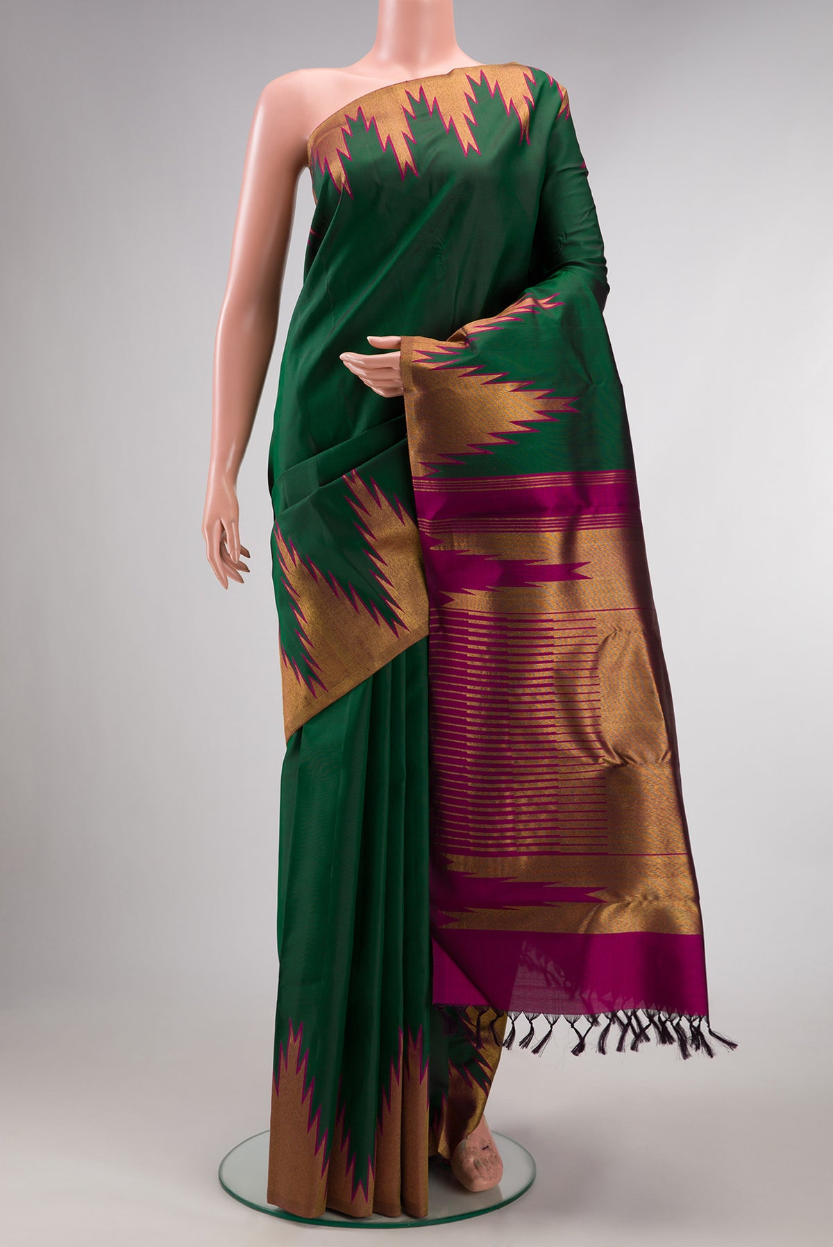 Pure Silk Bottle Green Kanchipuram Saree with Plain Body and Temple Border.  displayed on a mannequin
