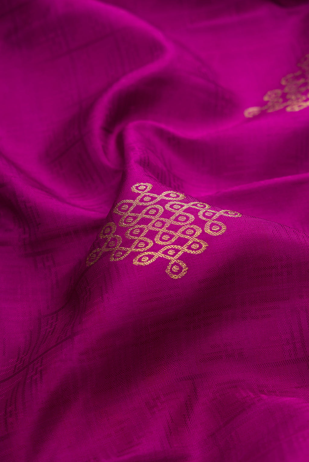 Close up of Pure Silk Magenta Kanjivaram Saree with Jacquard With Zari Butta on the body and Zari Border.  displaying folds