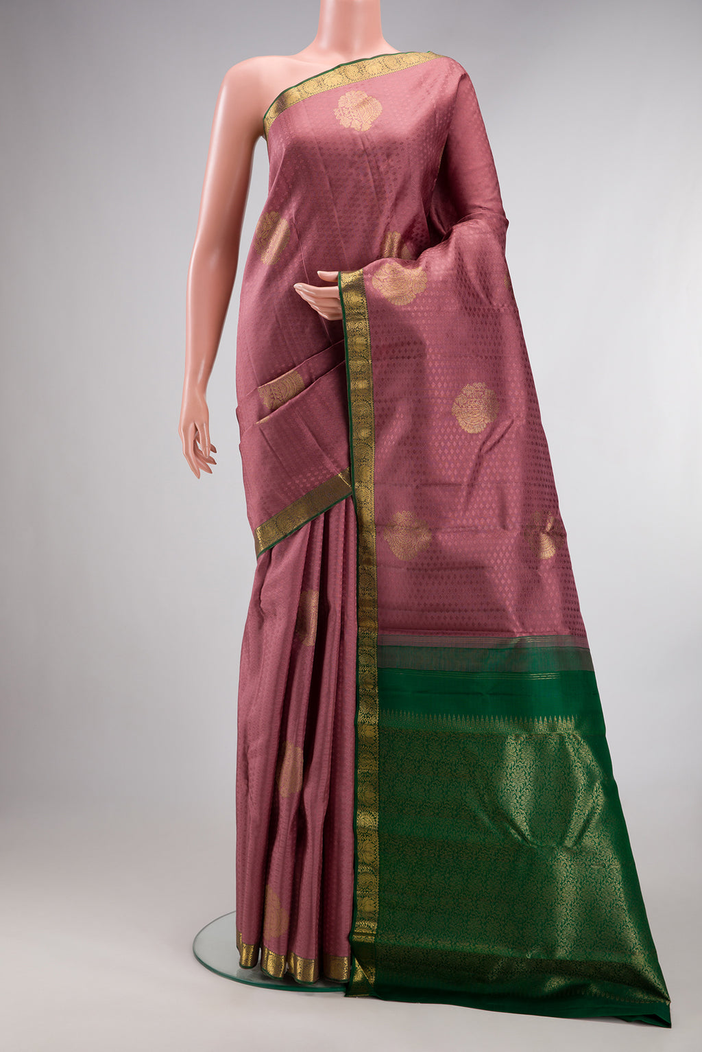 Pure Silk Peach Kanjivaram Saree with Jacquard With Zari Butta on the body and Zari Border.  displayed on a mannequin